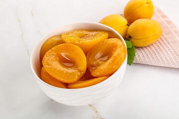 Few canned aprocots in the bowl