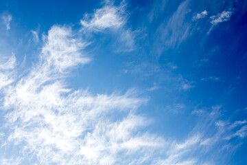 Idyllic white fluffy clouds in the blue sky