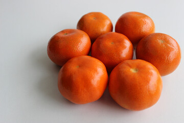 Flower Shaped Ripe Mandarins Lying On Clean White Surface Angle View  
