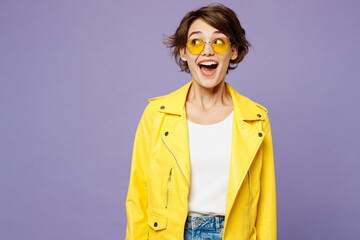 Young surprised fun shocked happy woman wears yellow shirt white t-shirt casual clothes glasses look aside on area mock up isolated on plain pastel light purple background studio. Lifestyle concept.