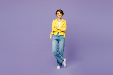 Full body young woman wears yellow shirt white t-shirt casual clothes glasses hold hands crossed folded look camera isolated on plain pastel light purple background studio portrait. Lifestyle concept.