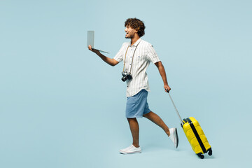 Full body traveler IT Indian man wears white casual clothes hold bag laptop pc computer isolated on...