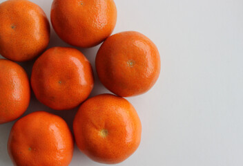 Heap Of Fresh Orange Tangerines Isolated On White At A Side Of Image. Stock Photo For Tangerine Backgrounds
