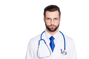 Fototapeta premium Portrait of trendy modern doc with stubble and modern hairstyle in white lab coat, tie and stethoscope on his neck, looking at camera, isolated on grey background