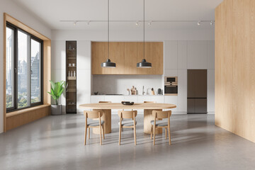 Stylish home kitchen interior with dining table and cabinet, panoramic window