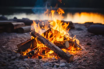 A pile of wood is burning in a fire pit on a beach © smth.design