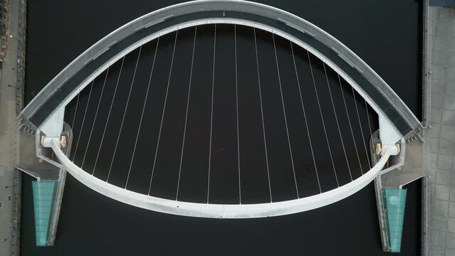 Aerial drone clip taken looking directly down on the Millennium Bridge in Gateshead as the drone rises over the Tyne River 