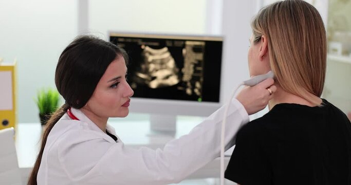 Doctor uses an ultrasound machine to examine patient neck