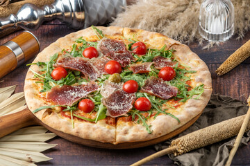 pizza with salami and tomatoes