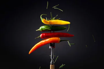 Raamstickers Colorful hot chili peppers sprinkled with rosemary. © Igor Normann