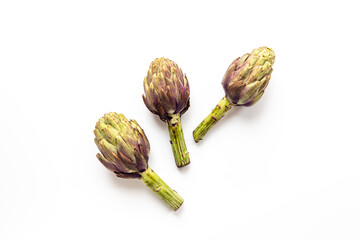 Fresh vegetables - raw artichokes. Green and purple artichoke flower buds - 791470313