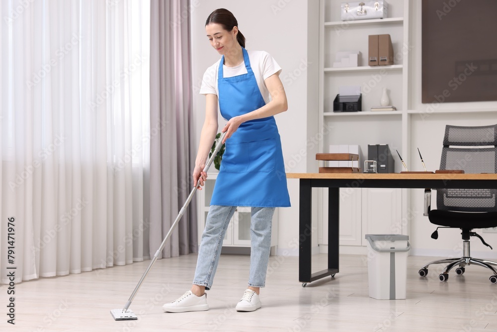 Poster Cleaning service. Woman washing floor with mop in office