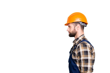 Profile portrait with copy space, empty place for advertisement, product of virile harsh repairer in shirt and overall isolated on grey background