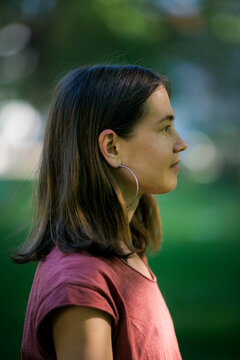 Captured in profile, the woman maintains a serene expression, exuding calmness and poise.