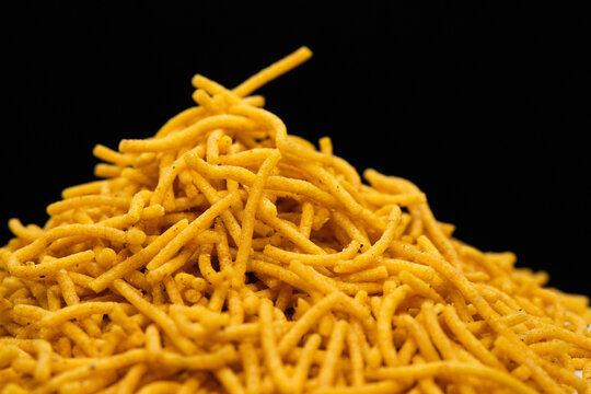 Alu bhujiya sev Indian snacks or namkeen in black background