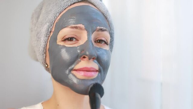 Woman with a cleansing face mask.