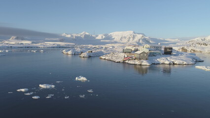 Fototapeta na wymiar Polar Antarctic Vernadsky Station Aerial View. Ocean Coast Open Water Surface. South Pole Settlement Base Landscape Drone Flight