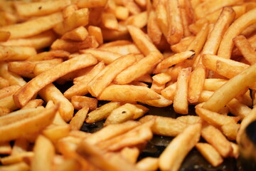 Close up of oily french fries potatoes background.