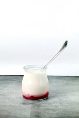Natural yogurts with strawberry syrup