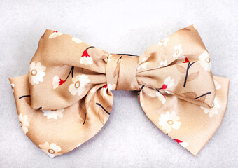 beige and floral colored hair bow clip on grey