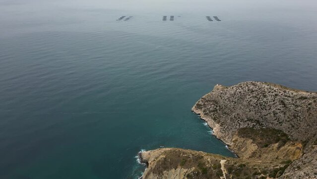 Aerial view of Mirador Morro de Toix and the fish farm off the coast of Calpe 4k