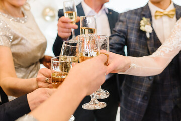 Cheers. People celebrate and raise glasses of wine for toast. Group of man and woman cheering with...