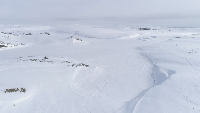 Snowmobile Drive on Snow Arctic Majestic Landscape. Drone Flight of Ski-doo Rider in Nature Winter Antarctica Expedition. Extreme Adrenaline Lifestyle in Iceland Aerial