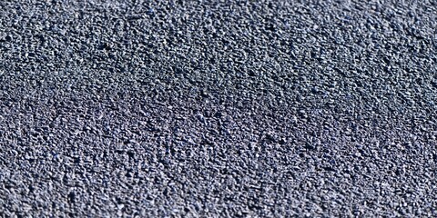 Road surface concepts: close-up photo of bituminous asphalt on a newly paved road