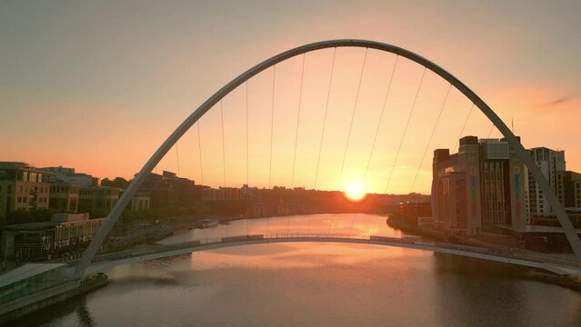 Drone rises over Tyne River, Millennium Bridge and Baltic Centre to reveal stunning autumn sunrise. Newcastle Gateshead 2023