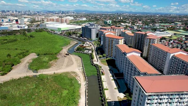 Sucat, Paranaque, Metro Manila, Philippines - Flyby aerial view of Field Residences, a condominium complex, and SM Sucat.