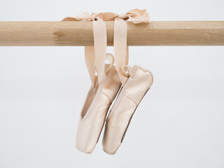 Ballerina gracefully poised at the ballet barre in a sunlit studio, practicing her pirouettes and perfecting her form amidst the serene ambiance of the dance sanctuary © Alena