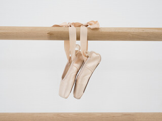 Ballerina gracefully poised at the ballet barre in a sunlit studio, practicing her pirouettes and perfecting her form amidst the serene ambiance of the dance sanctuary