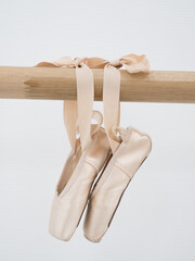 Ballerina gracefully poised at the ballet barre in a sunlit studio, practicing her pirouettes and perfecting her form amidst the serene ambiance of the dance sanctuary © Alena