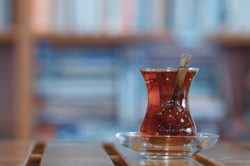 Traditional Turkish Tea Served in a Thin Waisted Glass on a Metallic Surface