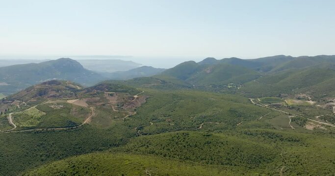 Aerial view on green mountains. On background is the Mediterranean Sea.