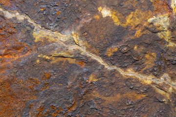 A macro shot of a rock at a close distance. Showing extreme detail and minerals that are in the rock.