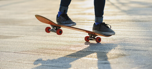 Skateboarder skateboarding outdoors in sunshine