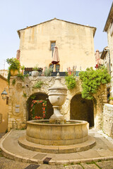 Fototapeta na wymiar Vintage Fountain in downtown of village Saint-Paul-de-Vence, France