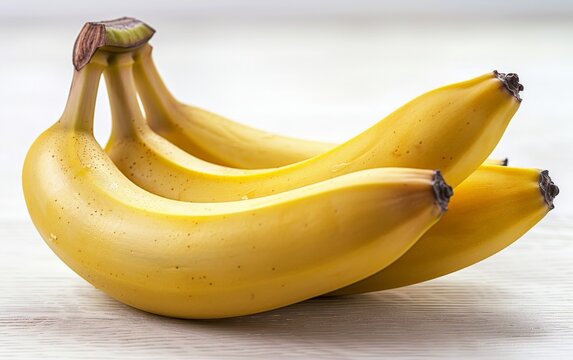 A bunch of ripe yellow bananas on a white table