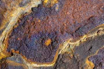 A macro shot of a rock at a close distance. Showing extreme detail and minerals that are in the rock.