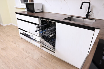 Built-in dishwasher with open door in kitchen