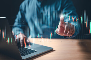 financial, chart, candlestick, trade, graph, index, invest, multi, report, statistic. A man is using a laptop to click on a graph. The graph is a series of lines that are moving up and down.