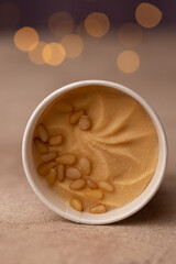 Craft natural ice cream in a paper bucket, the taste of lemon and pine nuts