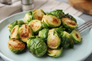 Delicious roasted Brussels sprouts on table, closeup - obrazy, fototapety, plakaty