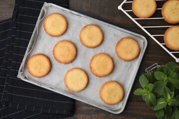Tasty sweet sugar cookies and mint on wooden table, flat lay
