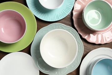 Beautiful ceramic dishware on wooden table, flat lay