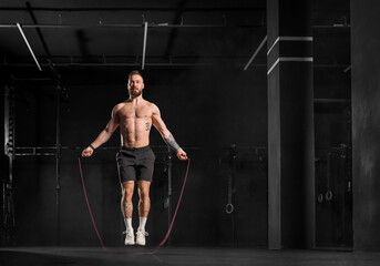 Man jumping rope, doing double-unders as part of crossfit workout. Routine workout for physical and...