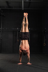 Rear view of handstand exercise, handstand push-ups. Routine workout for physical and mental health.