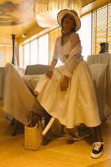 Beautiful tender woman in white dress posing. Beauty, fashion. Haircare. Cosmetics.