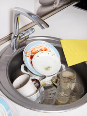 Top view of kitchen sink at home with dirty dishes. Work area in a home kitchen.